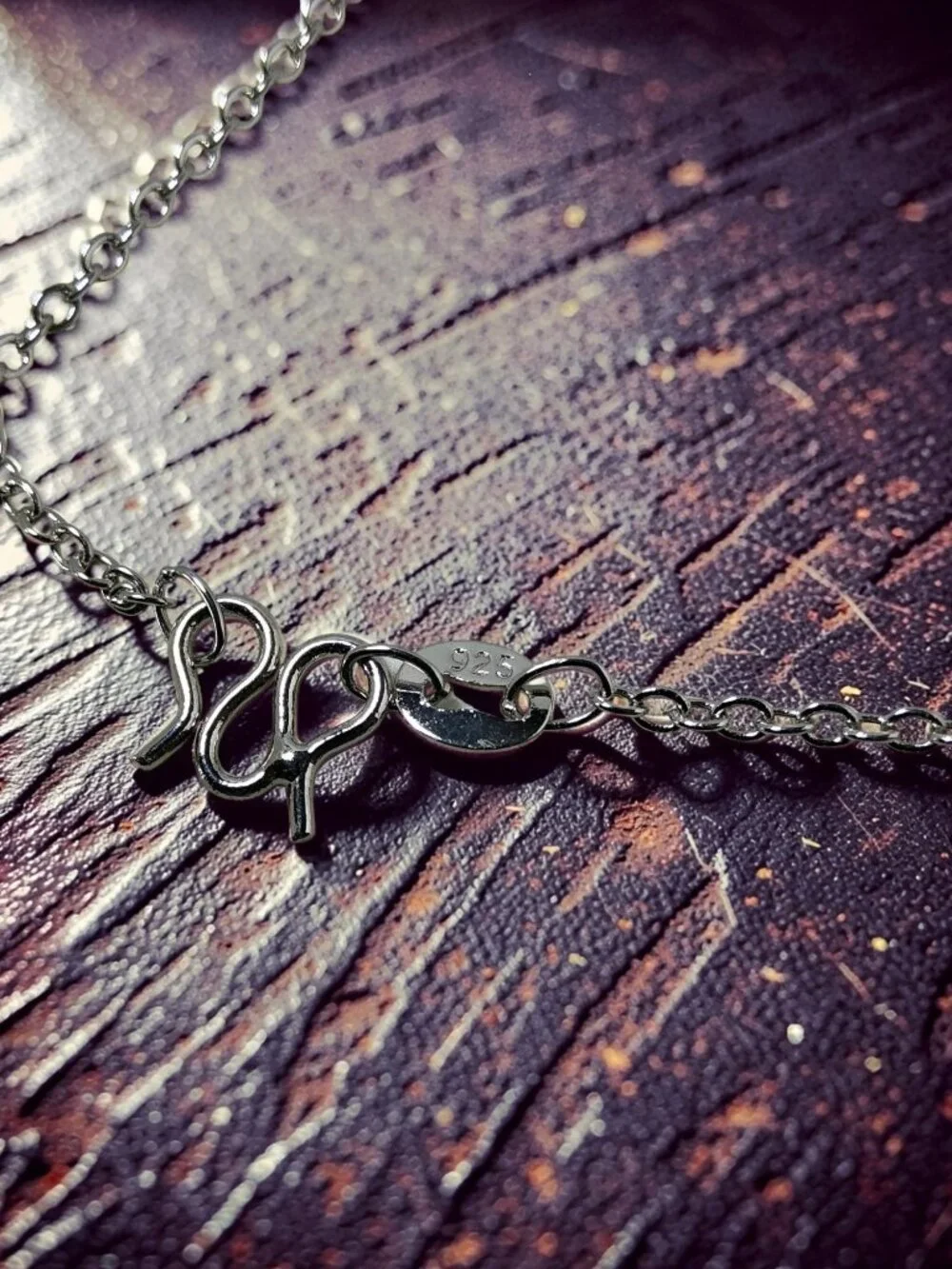 vintage Chrystal lined spiraled curled cross on a .925 sterling necklace